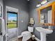 Stylish half-bathroom with modern fixtures and access to the outdoor patio at 3100 Lena Ln, Sarasota, FL 34240