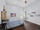 Well-lit bedroom featuring hardwood floors, ceiling fan, and outdoor access at 3100 Lena Ln, Sarasota, FL 34240