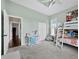 ' bedroom featuring a bunk bed, mint green walls, and ceiling fan at 3100 Lena Ln, Sarasota, FL 34240