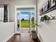 Inviting entryway with hardwood floors and view to horse pasture through open french doors at 3100 Lena Ln, Sarasota, FL 34240