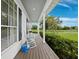 Charming front porch with rocking chairs and a watering can, perfect for relaxing and enjoying the scenery at 3100 Lena Ln, Sarasota, FL 34240