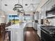 A spacious kitchen boasts an island, stainless steel appliances, and large windows with picturesque outdoor views at 3100 Lena Ln, Sarasota, FL 34240