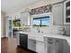 A modern kitchen features stainless steel appliances, sleek countertops, and a farmhouse sink beneath a window at 3100 Lena Ln, Sarasota, FL 34240