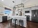 Modern kitchen with stainless steel appliances, white cabinets, and an island with seating at 3100 Lena Ln, Sarasota, FL 34240