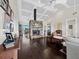 Spacious living room with stone fireplace, vaulted ceiling, and hardwood floors at 3100 Lena Ln, Sarasota, FL 34240