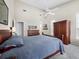 Spacious main bedroom featuring a high ceiling, ceiling fan, piano, and large closet at 3100 Lena Ln, Sarasota, FL 34240