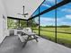 Enjoy the outdoors from this screened-in patio, complete with a ceiling fan and outdoor kitchen with pizza oven at 3100 Lena Ln, Sarasota, FL 34240