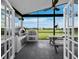 This outdoor patio has a pizza oven, outdoor grill, and picnic table, all overlooking a lush green backyard at 3100 Lena Ln, Sarasota, FL 34240