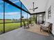 Relax on this screened patio, which has ceiling fans, wicker chairs, a picnic table, and a sprawling lawn at 3100 Lena Ln, Sarasota, FL 34240