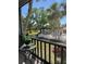 Scenic view from the balcony showcasing lush greenery, a community pool, and serene landscaping at 3245 Beneva Rd # 203, Sarasota, FL 34232