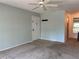 Bright living room with ceiling fan, neutral paint, and hallway to dining area at 3245 Beneva Rd # 203, Sarasota, FL 34232