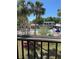 Balcony view with palm trees overlooking the inviting community pool and lounge area at 3245 Beneva Rd # 203, Sarasota, FL 34232