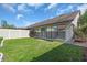 Fenced backyard with a well-maintained lawn and view of the home's exterior at 327 40Th W Ct, Palmetto, FL 34221