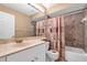 Bathroom with marble-like shower walls, marble countertop, and printed shower curtain at 327 40Th W Ct, Palmetto, FL 34221