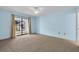Spacious bedroom with sliding glass door leading to the backyard and neutral carpet at 327 40Th W Ct, Palmetto, FL 34221