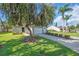 Charming single-story home with lush landscaping, mature tree, and a well-maintained lawn at 327 40Th W Ct, Palmetto, FL 34221