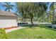 Well-maintained lawn with a mature shade tree in front of a home at 327 40Th W Ct, Palmetto, FL 34221