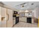 Kitchen with a breakfast bar, black appliances, and a ceiling fan at 327 40Th W Ct, Palmetto, FL 34221