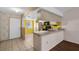 Kitchen and breakfast bar with plenty of lighting and an exterior door to the front at 327 40Th W Ct, Palmetto, FL 34221