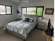Comfortable bedroom featuring a queen-sized bed, soft carpet, and plenty of natural light from the windows at 3764 Torrey Pines Blvd, Sarasota, FL 34238
