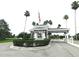 A gated community entrance with mature landscaping and palm trees adds a touch of security and curb appeal at 3764 Torrey Pines Blvd, Sarasota, FL 34238