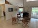 Dining room area next to a sliding glass door leading to a swimming pool at 3764 Torrey Pines Blvd, Sarasota, FL 34238
