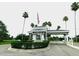 Gated community entrance features an American flag, palm trees, and a decorative fountain at 3764 Torrey Pines Blvd, Sarasota, FL 34238