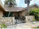 Inviting stone entrance with a decorative gate and well-maintained landscaping at 3764 Torrey Pines Blvd, Sarasota, FL 34238