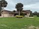 Inviting single-story home with a well-manicured lawn, mature palm trees, and an attached two-car garage at 3764 Torrey Pines Blvd, Sarasota, FL 34238