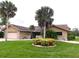 Beautiful single-story home featuring a lush lawn, mature palms, and decorative stone accents at 3764 Torrey Pines Blvd, Sarasota, FL 34238