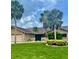 Inviting single-story home featuring lush landscaping, stone accents, and mature palm trees at 3764 Torrey Pines Blvd, Sarasota, FL 34238