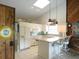 Bright and airy kitchen featuring white cabinets, a breakfast bar, and modern appliances at 3764 Torrey Pines Blvd, Sarasota, FL 34238