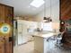 Well-lit kitchen with white cabinetry, modern appliances, and a cozy breakfast bar at 3764 Torrey Pines Blvd, Sarasota, FL 34238
