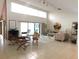 Spacious living room with tiled floors and multiple seating areas at 3764 Torrey Pines Blvd, Sarasota, FL 34238