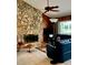 Cozy living room with a floor-to-ceiling stone fireplace and comfortable seating at 3764 Torrey Pines Blvd, Sarasota, FL 34238