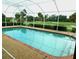 A screened pool overlooks a verdant golf course with mature trees at 3764 Torrey Pines Blvd, Sarasota, FL 34238