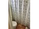 Cozy bathroom with decorative tile flooring, decorative shower curtain and newer toilet at 3767 Pinstar Ter, North Port, FL 34287