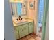 Bathroom features vessel sink, green vanity and a shower/tub combo at 3767 Pinstar Ter, North Port, FL 34287