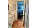 Bathroom featuring a white vanity, decorative tile flooring, and a glimpse into the bedroom at 3767 Pinstar Ter, North Port, FL 34287