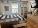 This bedroom features tile floors, a dresser, and a view out of the window at 3767 Pinstar Ter, North Port, FL 34287