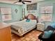 Cozy bedroom features a ceiling fan, ample natural light and tropical decor at 3767 Pinstar Ter, North Port, FL 34287