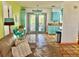Inviting living area with vintage tile flooring and views to outdoor deck through double French doors at 3767 Pinstar Ter, North Port, FL 34287