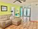 Cozy living room featuring terracotta tile flooring and an open view to the kitchen at 3767 Pinstar Ter, North Port, FL 34287