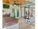 Screened-in patio boasts a hot tub, patio swing, and outdoor exercise equipment at 3767 Pinstar Ter, North Port, FL 34287