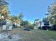 Spacious yard with an RV, boat, trailer, and a shed surrounded by green grass and shady trees at 3767 Pinstar Ter, North Port, FL 34287
