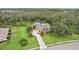 Stunning aerial view of custom home with sprawling grounds, mature trees and circular driveway at 3906 Twin Rivers Trl, Parrish, FL 34219