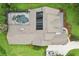 Aerial view of the home's roof and screened in pool with solar panels at 3906 Twin Rivers Trl, Parrish, FL 34219