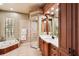 Lavish bathroom showcasing a jacuzzi tub, a walk-in shower, and elegant fixtures and cabinets at 3906 Twin Rivers Trl, Parrish, FL 34219