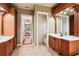 Primary bath featuring dual vanities, wood cabinets, and tile flooring at 3906 Twin Rivers Trl, Parrish, FL 34219