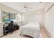 Cozy bedroom with neutral tones, a ceiling fan, and ample natural light from a large window at 3906 Twin Rivers Trl, Parrish, FL 34219